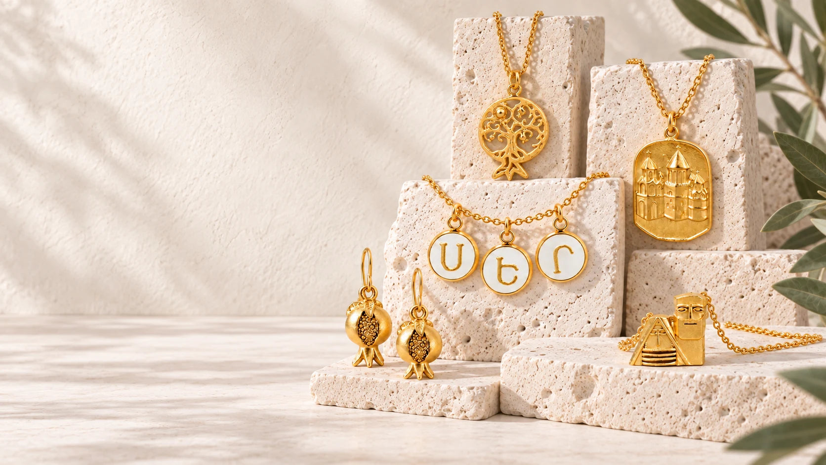 Pomegranate jewelry arranged in a quiet still life on ivory.